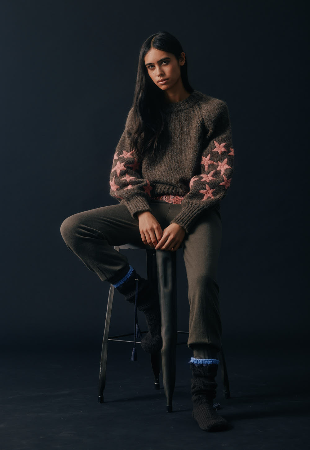 Baby alpaca sweater with pink embroidery on sleeves worn on model, soft textured knit