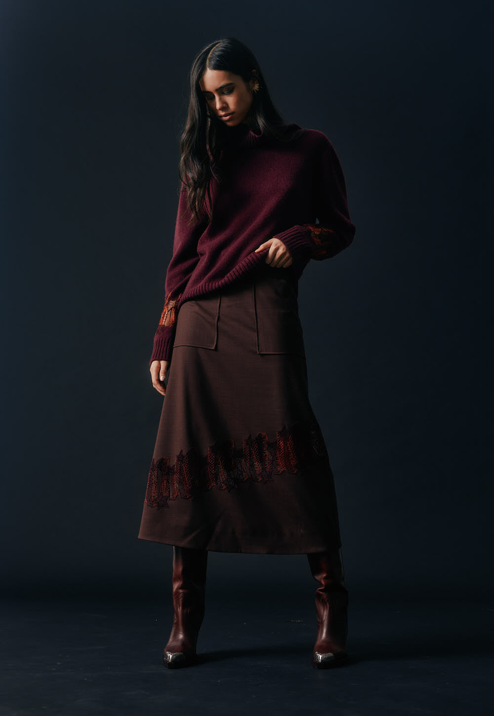 Model wearing the Antonia Zander Romina Skirt in bordeaux styled with a matching cashmere knit and leather boots.