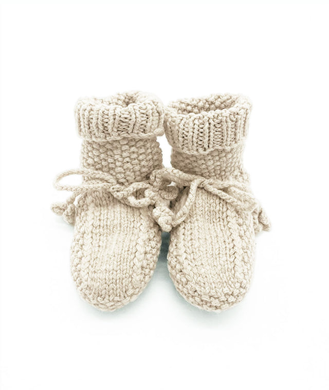 hand knitted cashmere baby booties with cord so tie. bubble knit pattern